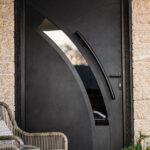 custom designed and crafted black exterior door with carbon detailing