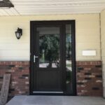 custom black entrance door, 1/3 black panel and 2/3 glass with glass side-lite on the right side.